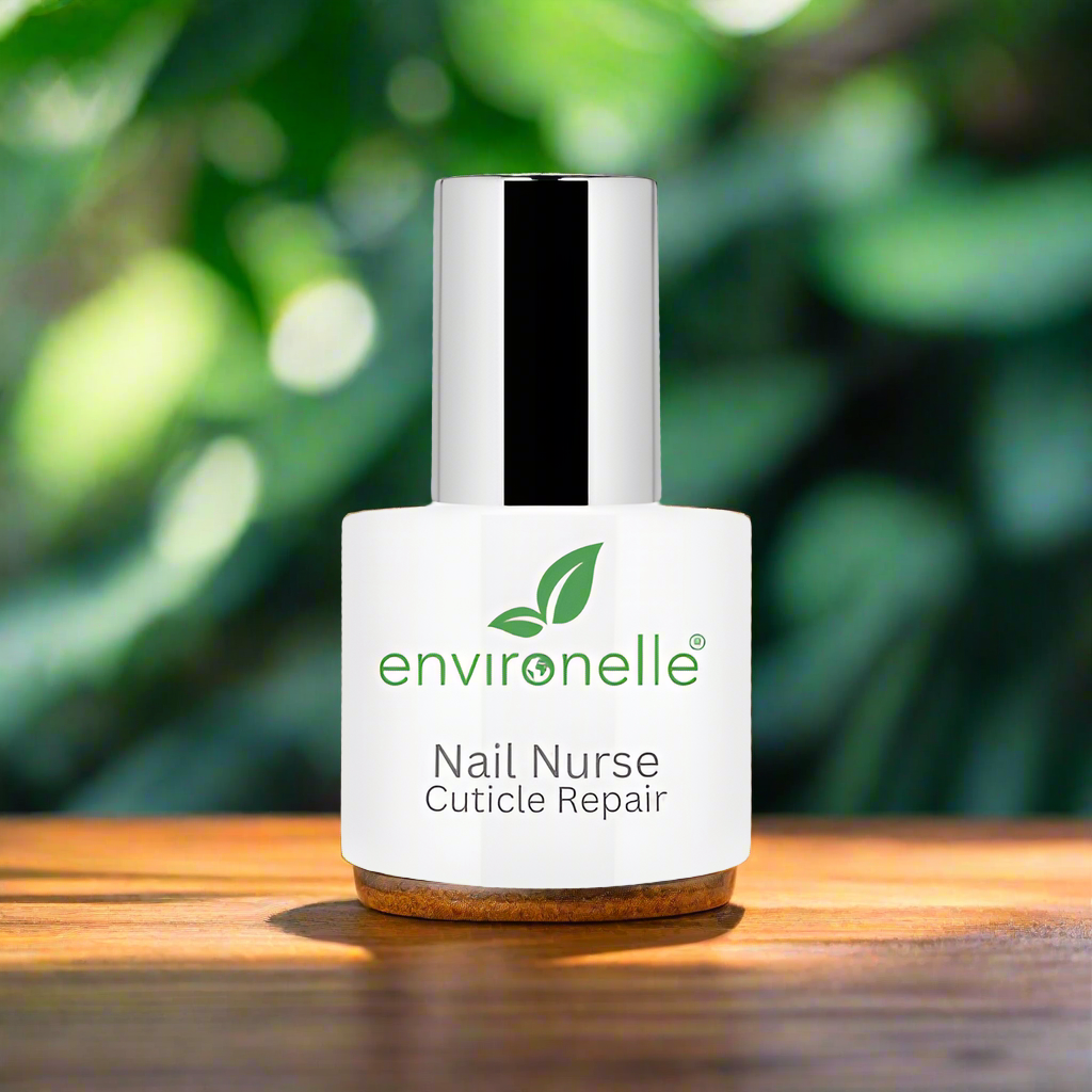 Environelle Nail Nurse Cuticle Repair bottle on a wooden surface with a blurred green leafy background
