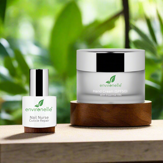


A handcare kit featuring a nail nurse container and a larger hand cream container, both labeled with the brand Environelle, displayed on walnut pedestals with a palm tree in the background.