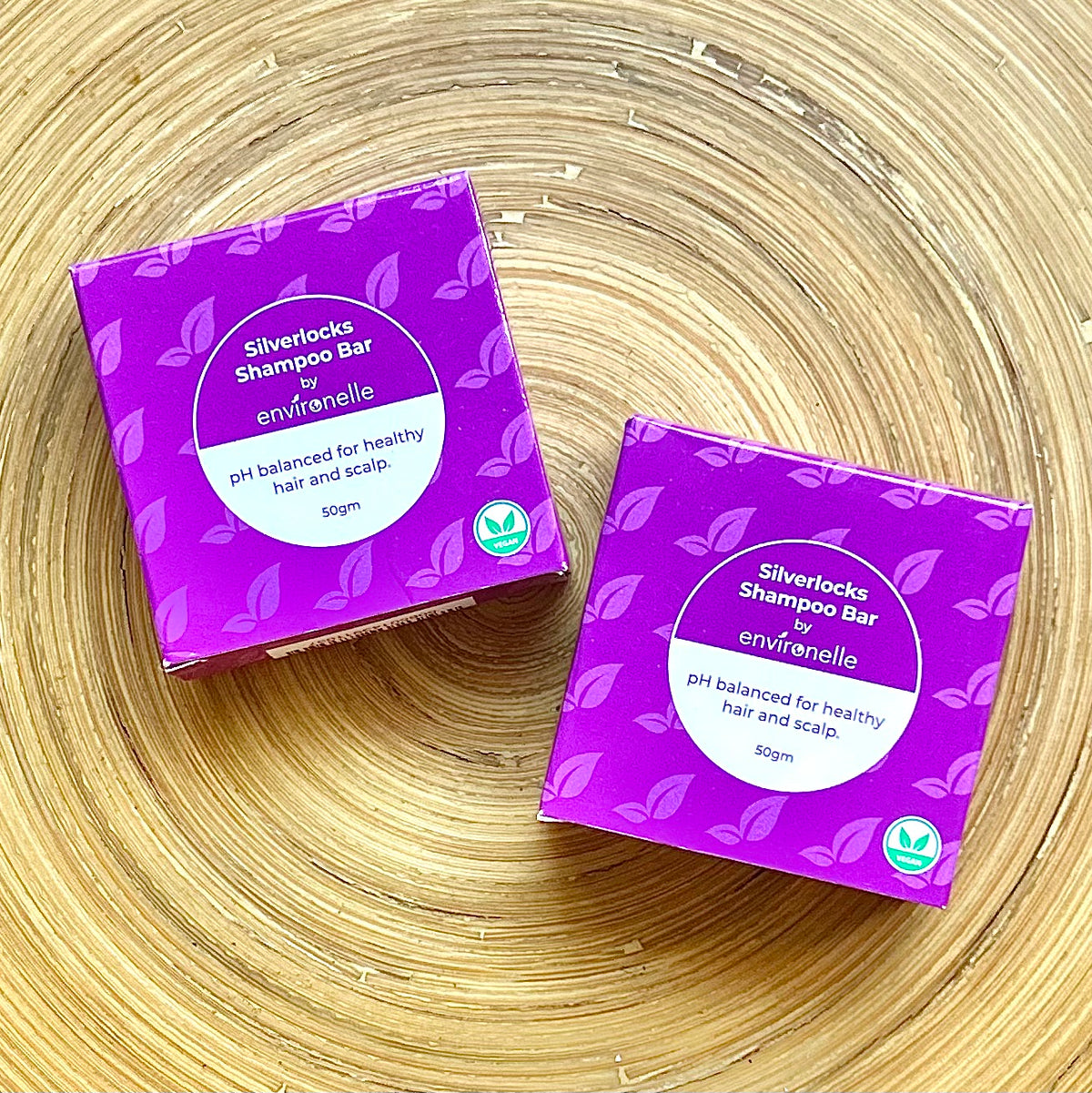 Two purple boxes of Silverlocks Shampoo Bar by Envirolene on a wooden surface